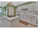 Well-lit kitchen featuring white cabinets, tile floors, and a kitchen island at 238 Crooked Tree Trl, Deland, FL 32724