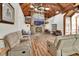 Spacious living room featuring a stone fireplace, high ceilings, and wood floors at 238 Crooked Tree Trl, Deland, FL 32724