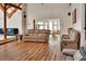 Open-concept living room showcasing wood floors and a view into dining area with bright sunlight at 238 Crooked Tree Trl, Deland, FL 32724