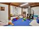 Bright playroom features a spiral staircase, wood beam, and window nook at 238 Crooked Tree Trl, Deland, FL 32724