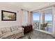 Charming living room with balcony, comfortable seating, and a picturesque ocean view at 2515 S Atlantic Ave # 401, Daytona Beach Shores, FL 32118