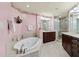 Elegant bathroom featuring a soaking tub, dual sinks, and a walk-in shower at 2515 S Atlantic Ave # 401, Daytona Beach Shores, FL 32118