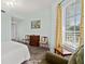 Bright bedroom features tile floors, neutral walls, and a relaxing sitting area by the window at 2515 S Atlantic Ave # 401, Daytona Beach Shores, FL 32118
