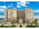 Stunning exterior view of a beachfront condominium with meticulous landscaping and beautiful blue skies at 2515 S Atlantic Ave # 401, Daytona Beach Shores, FL 32118