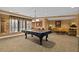 Spacious game room featuring a pool table, seating, and natural light at 2515 S Atlantic Ave # 401, Daytona Beach Shores, FL 32118