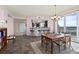 Open-concept dining and living area with bar, and balcony access at 2515 S Atlantic Ave # 401, Daytona Beach Shores, FL 32118