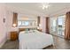 A spacious main bedroom features neutral colors and a mirrored wall with balcony access at 2515 S Atlantic Ave # 401, Daytona Beach Shores, FL 32118