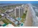 Scenic aerial view of beachfront condos with pools and direct beach access along the coastline at 2555 S Atlantic Ave # 1007, Daytona Beach Shores, FL 32118