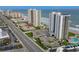 Aerial view of condo buildings, beach access, pool, and surrounding buildings at 2555 S Atlantic Ave # 1007, Daytona Beach Shores, FL 32118