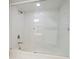 Clean and bright bathroom with tile surround and sliding glass shower door at 2555 S Atlantic Ave # 1007, Daytona Beach Shores, FL 32118