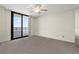 Comfortable bedroom with ceiling fan, neutral carpet and access to balcony offering panoramic views at 2555 S Atlantic Ave # 1007, Daytona Beach Shores, FL 32118