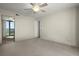 Bright bedroom with ceiling fan, neutral carpet and access to balcony offering panoramic views at 2555 S Atlantic Ave # 1007, Daytona Beach Shores, FL 32118