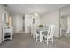Dining room with a glass-top table, white wicker chairs, and mirrored wall at 2555 S Atlantic Ave # 1007, Daytona Beach Shores, FL 32118
