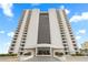 Striking exterior elevation of a tall condominium building with a glass facade and private balconies at 2555 S Atlantic Ave # 1007, Daytona Beach Shores, FL 32118
