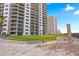 High-rise condo building near the beach with lawn and outside shower for residents at 2555 S Atlantic Ave # 1007, Daytona Beach Shores, FL 32118