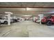 Well-lit parking garage with ample spaces, including a red Jeep at the forefront at 2555 S Atlantic Ave # 1007, Daytona Beach Shores, FL 32118