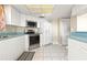 Bright kitchen featuring white cabinetry, stainless steel appliances, and tile flooring at 2555 S Atlantic Ave # 1007, Daytona Beach Shores, FL 32118