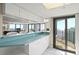 Kitchen bar with white cabinets opening onto a living area with ocean views and access to the balcony at 2555 S Atlantic Ave # 1007, Daytona Beach Shores, FL 32118