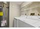 Functional laundry area with washer, dryer, and shelving for efficient organization at 2555 S Atlantic Ave # 1007, Daytona Beach Shores, FL 32118
