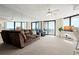 Spacious living room featuring a comfortable sofa and stunning ocean views through large windows at 2555 S Atlantic Ave # 1007, Daytona Beach Shores, FL 32118