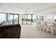 Relax in this bright and airy living room featuring a ceiling fan and balcony access at 2555 S Atlantic Ave # 1007, Daytona Beach Shores, FL 32118