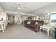 Comfortable living room with carpet, large windows, and dining area in open concept design at 2555 S Atlantic Ave # 1007, Daytona Beach Shores, FL 32118