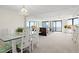 Open-concept living room with balcony access, featuring a dining area and comfortable seating at 2555 S Atlantic Ave # 1007, Daytona Beach Shores, FL 32118