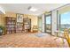 Reading lounge with books, comfortable seating, and views of the pool deck at 2555 S Atlantic Ave # 1007, Daytona Beach Shores, FL 32118
