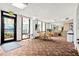 Comfortable lounge area with tables, chairs, and a large exit leading to an outside deck at 2555 S Atlantic Ave # 1007, Daytona Beach Shores, FL 32118