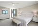 Main bedroom featuring white furniture, a ceiling fan, and a sliding glass door to the balcony at 2555 S Atlantic Ave # 1007, Daytona Beach Shores, FL 32118