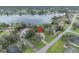 Scenic aerial view of a lakeside property with mature trees, showcasing its idyllic setting and community at 2557 Shiprock Ct, Deltona, FL 32738