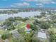Overhead view of the property with a pool, surrounded by lush greenery, community, and serene lake at 2557 Shiprock Ct, Deltona, FL 32738