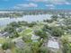 Overhead view of the property with a pool, surrounded by lush greenery, community, and serene lake at 2557 Shiprock Ct, Deltona, FL 32738