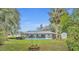 A beautifully landscaped backyard with a large screened pool and mature trees at 2557 Shiprock Ct, Deltona, FL 32738