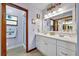 Bathroom boasts double vanity with wood-trimmed walk-in shower and plenty of natural light at 2557 Shiprock Ct, Deltona, FL 32738