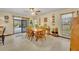 Cozy dining area with a wooden table and chairs, and a view of the outdoor pool at 2557 Shiprock Ct, Deltona, FL 32738