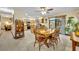 Dining area with wood table, and view of the kitchen and sliding doors to the outdoor pool at 2557 Shiprock Ct, Deltona, FL 32738