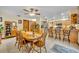 Open-concept dining area connecting to the kitchen with an island and bar stool seating at 2557 Shiprock Ct, Deltona, FL 32738