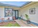 Covered entry features double doors, decorative accents, and landscaping at 2557 Shiprock Ct, Deltona, FL 32738