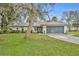 Charming single-story home with well-manicured lawn, lush landscaping, and attached two-car garage at 2557 Shiprock Ct, Deltona, FL 32738