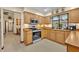 Bright kitchen featuring wood cabinets, stainless steel appliances, and a window with views at 2557 Shiprock Ct, Deltona, FL 32738