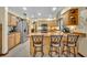 Kitchen area with stainless steel appliances, wood cabinets, and an island with bar seating at 2557 Shiprock Ct, Deltona, FL 32738