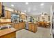 Well-lit kitchen and dining area featuring wood cabinets, modern appliances, and tile flooring at 2557 Shiprock Ct, Deltona, FL 32738