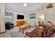 Spacious living room featuring a large window, ceiling fan, recliner, leather sofa, and light woodgrain floors at 2557 Shiprock Ct, Deltona, FL 32738