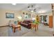 Comfortable living room featuring a ceiling fan, recliner, leather sofa, and light woodgrain floors at 2557 Shiprock Ct, Deltona, FL 32738