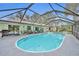Large screened-in pool boasts clear blue water and a lounge area for relaxing at 2557 Shiprock Ct, Deltona, FL 32738