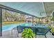Screened-in pool is surrounded by outdoor furniture and a manicured lawn at 2557 Shiprock Ct, Deltona, FL 32738