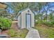 A functional backyard storage shed with a teal trim, offering extra storage and enhancing the property's organization at 2557 Shiprock Ct, Deltona, FL 32738