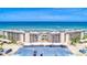 Stunning aerial view of beachfront condos with a pool, parking, and ocean views at 2700 Ocean Shore Blvd # 305, Ormond Beach, FL 32176