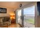 Inviting balcony featuring seating area with ocean views, accessible from a cozy living room at 2700 Ocean Shore Blvd # 305, Ormond Beach, FL 32176